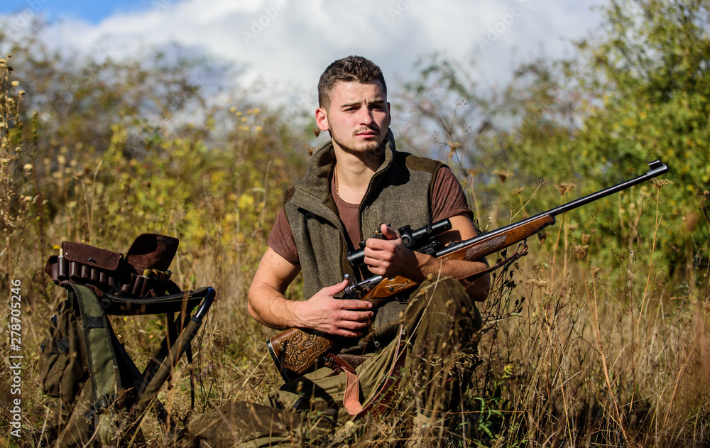 Man with rifle hunting equipment nature background. Prepare for hunting. What you should have while hunting nature environment. Recharge rifle concept. Hunting equipment and safety measures Man with rifle hunting equipment nature background. Prepare for hunting. What you should have while hunting nature environment. Recharge rifle concept. Hunting equipment and safety measures