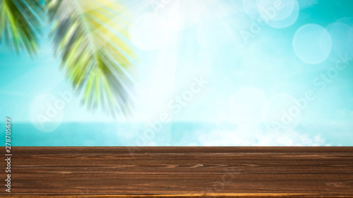 Table background and the wooden board and palm leaves in the beautiful sunshine view