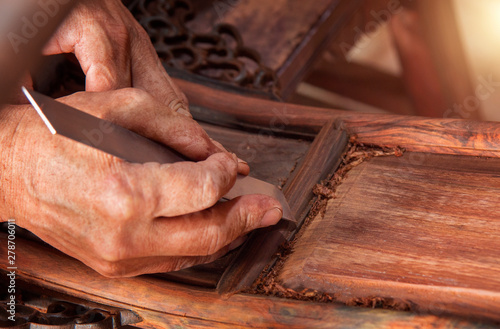 фотографія Workers grind furniture with scrapers