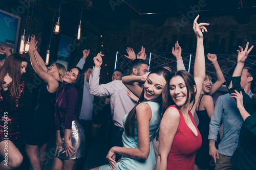 Nice-looking attractive lovely glamorous shine cheerful positive stylish smart ladies and gentlemen having fun festal celebratory in modern fashionable luxury place indoors