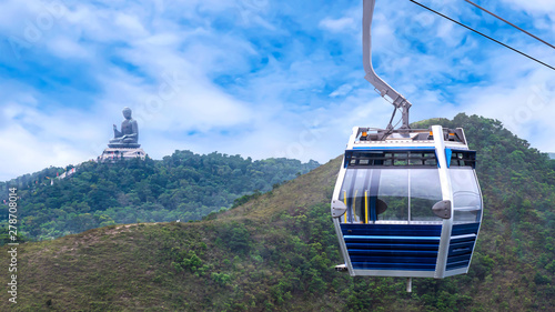 Hong Kong cable car over green mountain with Giant Buddha statue 1