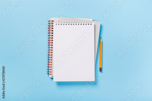 Canvas Print school notebook on a blue background, spiral notepad on a table
