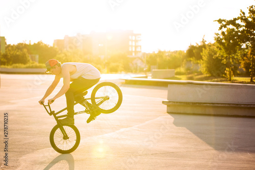 Male bmx bike rider at sunset horizontal