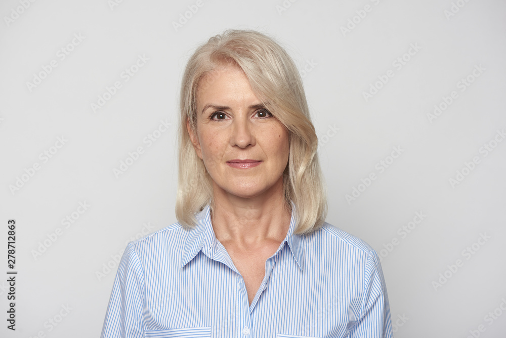 pretty old woman is smiling at camera isolated over gray background pretty old woman is smiling at camera isolated over gray background