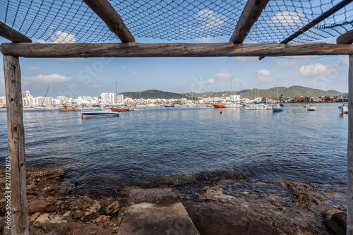 Old stone pier and fisherman house in bay and beach of Sant Antoni de Portmany, Ibiza Island, Balearic islands. Spain. photo