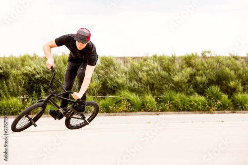BMX male rider leaning hard into a corner