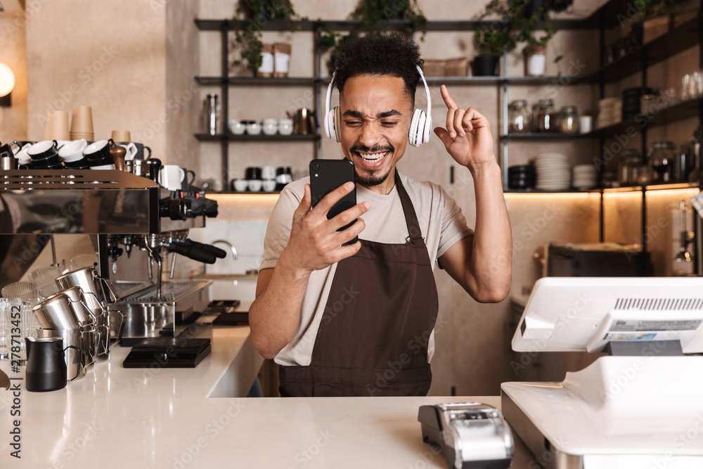 Smiling attractive man barista standing Smiling attractive man barista standing