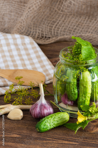 pickled cucumbers on a wooden background