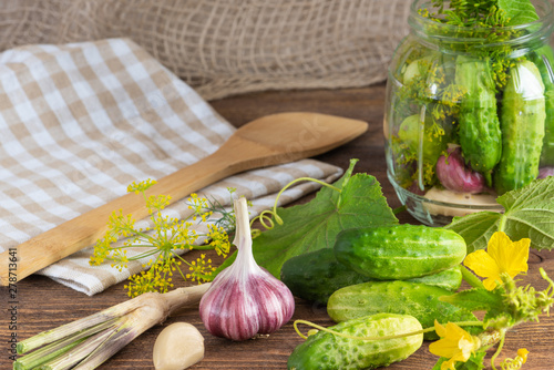 pickled cucumbers on a wooden background photo