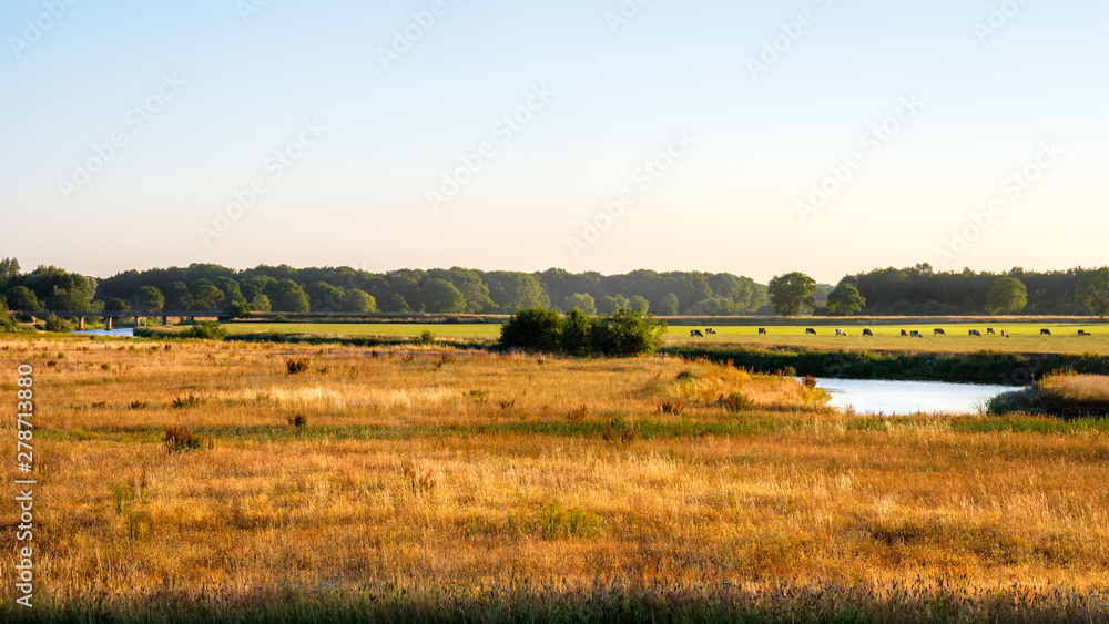 In the eastern Netherlands there is a valley of the river Vecht (Vechtdal in Dutch). The river is 100 miles long. The sun is setting on a June evening at the valley near the small village Marienberg.