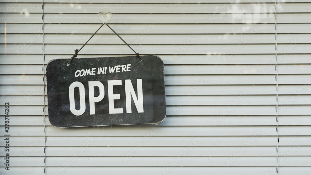 open and closed sign in the window with blind shade background open and closed sign in the window with blind shade background