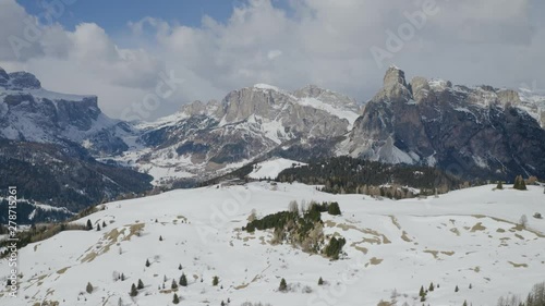 Aerial, snowy Dolomites mountains, huge peaks and beautiful winter landscape