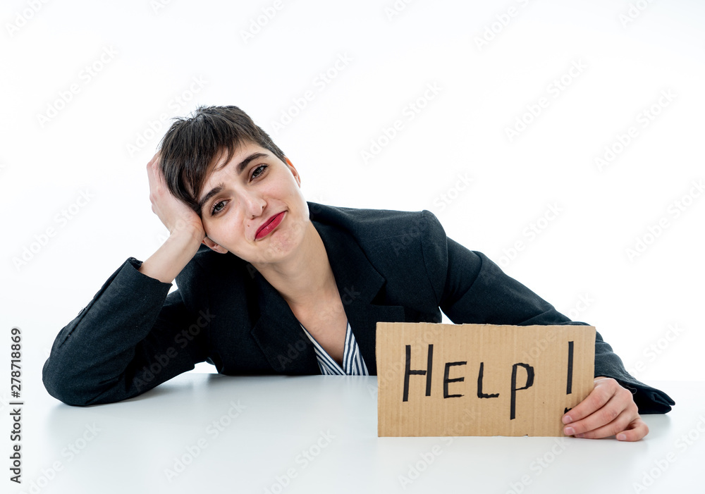 Beautiful young business woman overwhelmed and desperate holding a help sign Beautiful young business woman overwhelmed and desperate holding a help sign