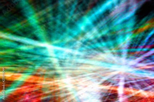 Abstract blurred background of diffused beams of colored light on the wall