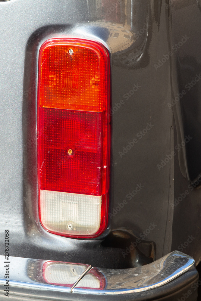 Fototapeta premium Taillight of an old silver car minibus 