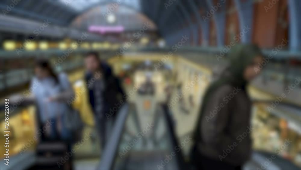 Anonymous travelers Going Up Escalator at Large Railway Station Anonymous travelers Going Up Escalator at Large Railway Station