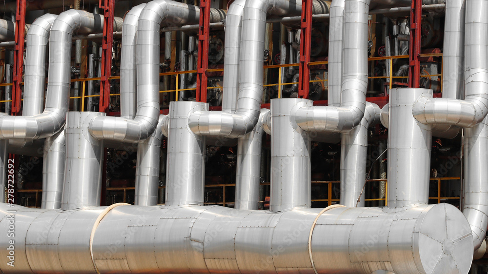 Industrial area of the plant. Oil refining equipment and pipelines of the plant close-up Industrial area of the plant. Oil refining equipment and pipelines of the plant close-up