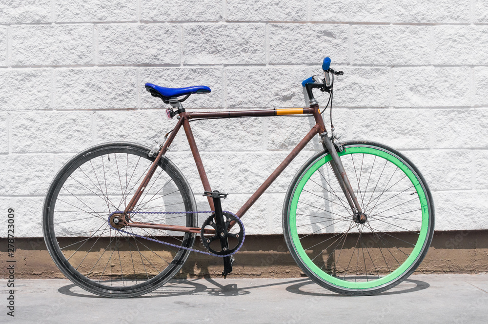 Old fixed gear bicycle on white wall background Old fixed gear bicycle on white wall background