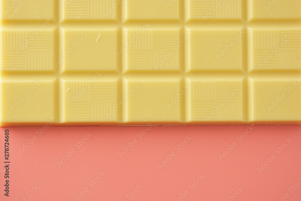 White chocolate isolated over pink background. Copy space. White chocolate isolated over pink background. Copy space.