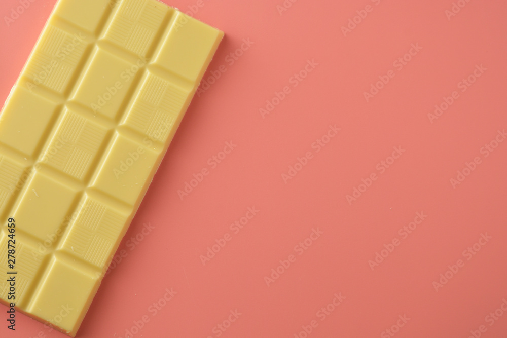 White chocolate isolated over pink background. Copy space. White chocolate isolated over pink background. Copy space.