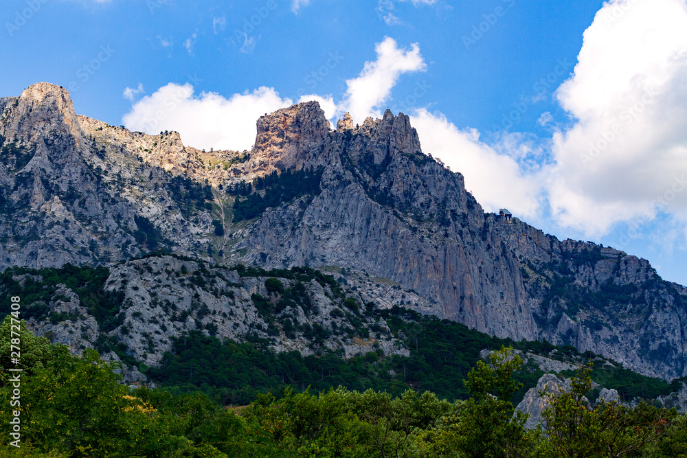 Cliffs of AI-Petri mountain against bluse sky and white clouds