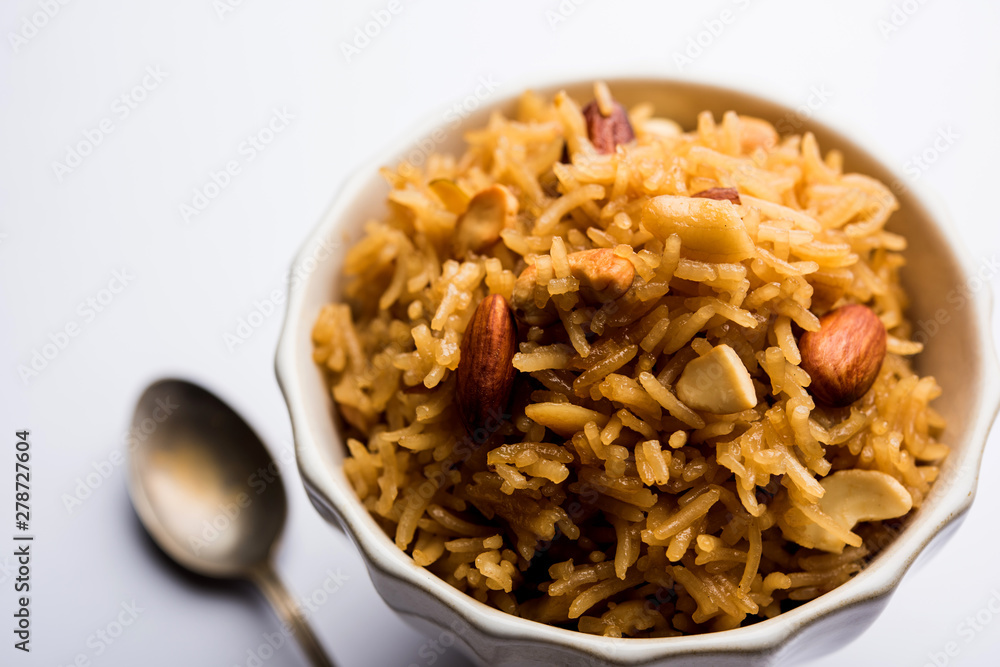 Traditional Jaggery Rice or Gur wale chawal in Hindi, served in a bowl with spoon. selective focus