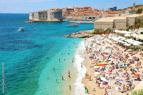 Fototapeta Naklejka Na Ścianę i Meble -  DUBROVNIK, CROATIA - JULY 12, 2019: Aerial view of Dubrovnik old town and Banje beach, Adriatic sea