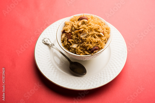 Traditional Jaggery Rice or Gur wale chawal in Hindi, served in a bowl with spoon. selective focus photo