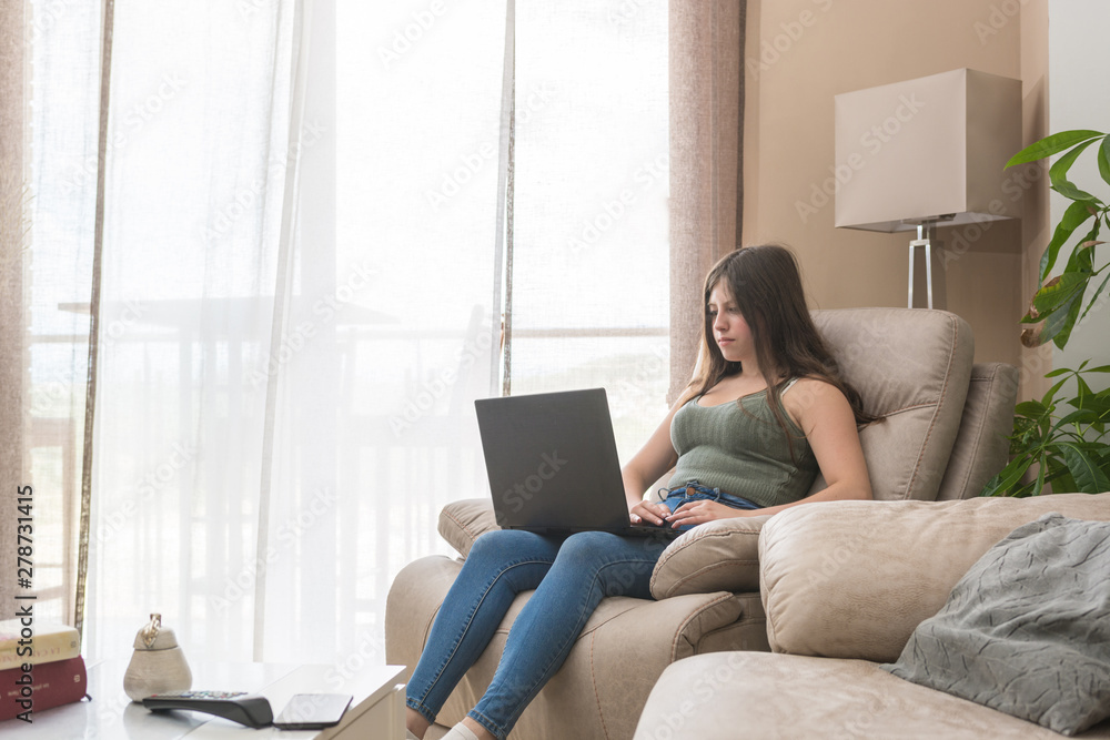 Teenage girl lying in the armchair of her home Teenage girl lying in the armchair of her home
