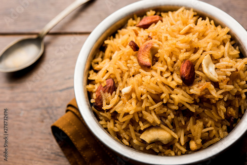 Traditional Jaggery Rice or Gur wale chawal in Hindi, served in a bowl with spoon. selective focus photo