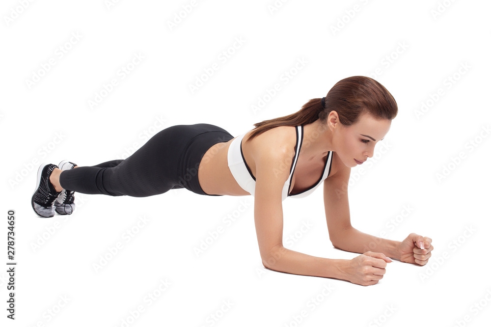 Young sporty woman doing plank exercise isolated Young sporty woman doing plank exercise isolated
