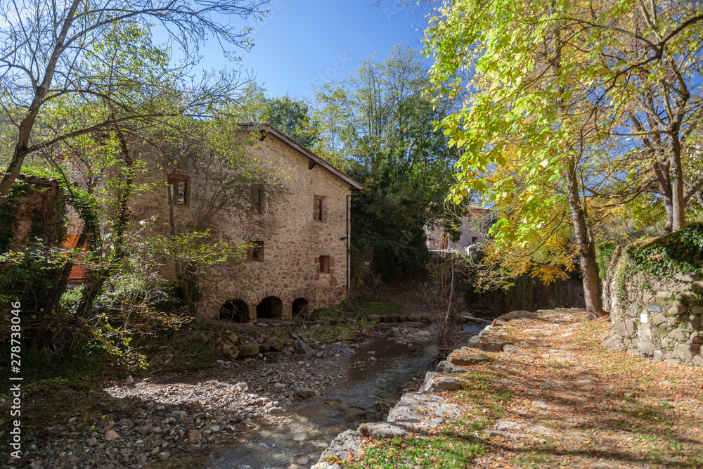 Sant Joan de les Abadesses, Catalonia, Spain. Old windmill close to river.