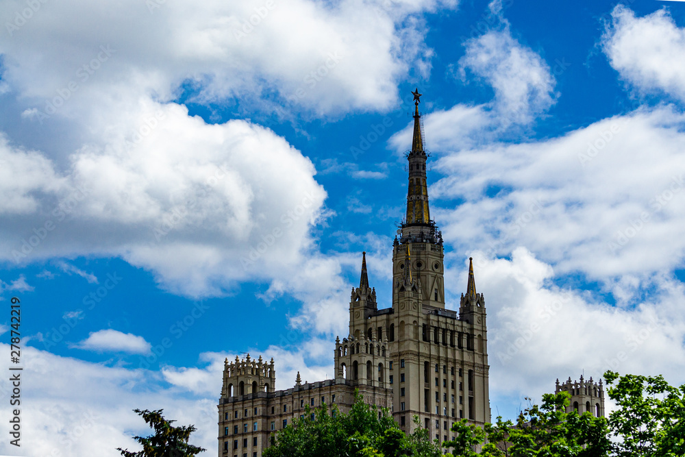 View on high-rise building on Kudrinskaya Square against blue sky in white clouds. Majestic high-rise building aspires to heavenly heights. Moscow, Russia, June, 2019 View on high-rise building on Kudrinskaya Square against blue sky in white clouds. Majestic high-rise building aspires to heavenly heights. Moscow, Russia, June, 2019