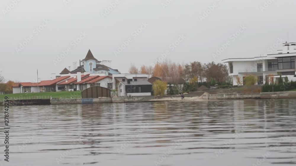 View from river to bank with modern architecture View from river to bank with modern architecture