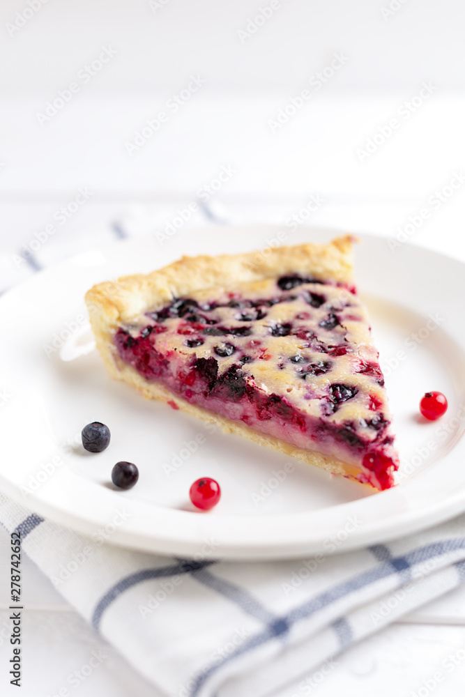 Slice of Blueberry and red currant Pie on rustic wooden table Slice of Blueberry and red currant Pie on rustic wooden table