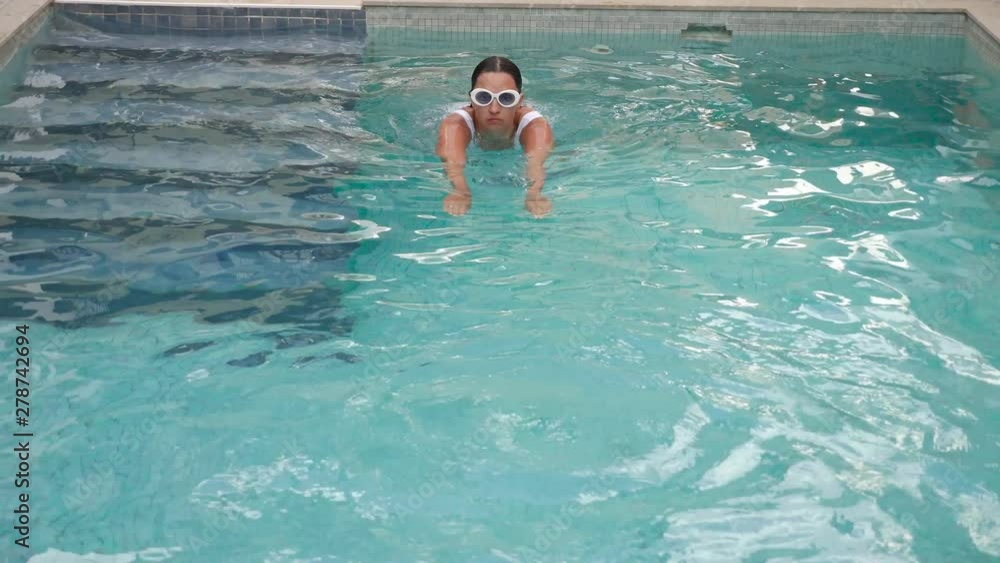 young sexy woman in white swimsuit swimming in pool young sexy woman in white swimsuit swimming in pool