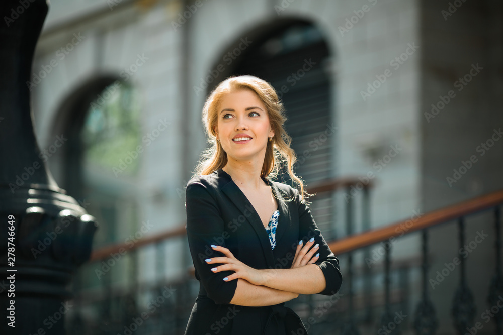 Fototapeta premium portrait of a beautiful young woman in a black suit