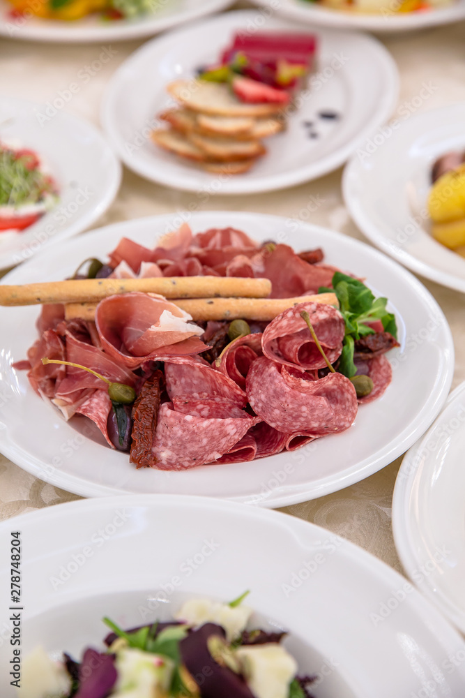 Food Table Celebration Delicious Party Meal Concept. A lot of food. Served for wedding, anniversary, other holiday. Banquet dishes in the restaurant Food Table Celebration Delicious Party Meal Concept. A lot of food. Served for wedding, anniversary, other holiday. Banquet dishes in the restaurant