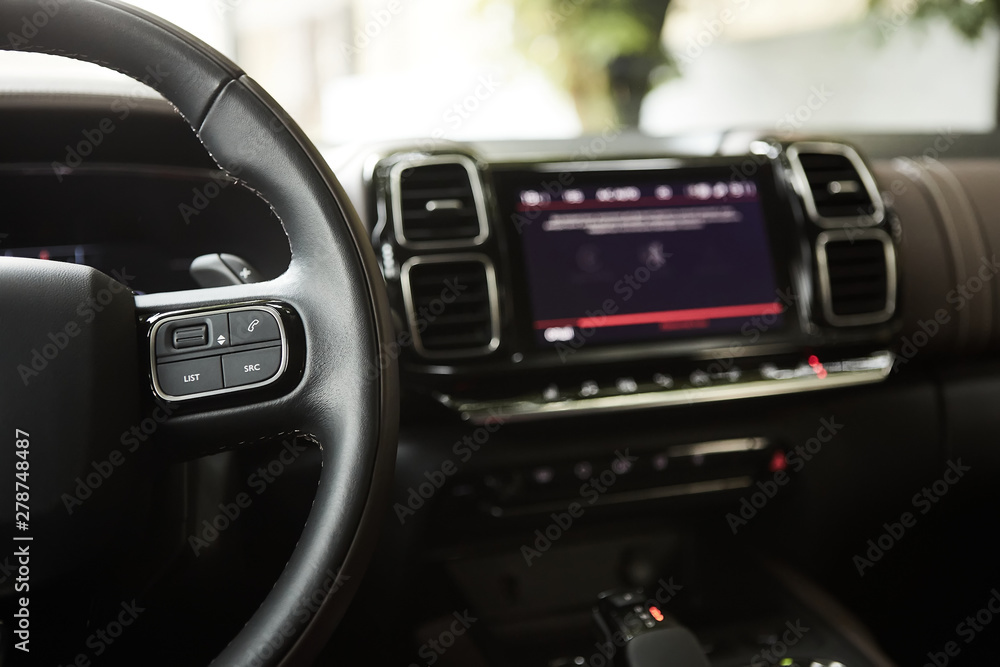 selective focus of steering wheel near gear shift handle in luxury car