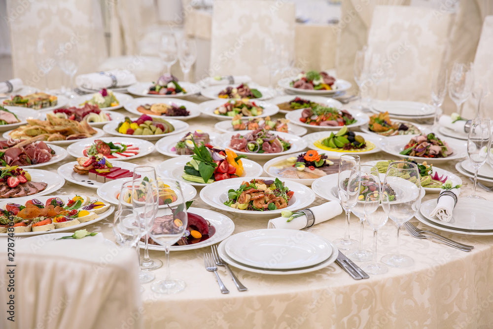 Fototapeta premium Food Table Celebration Delicious Party Meal Concept. A lot of food. Served for wedding, anniversary, other holiday. Banquet dishes in the restaurant