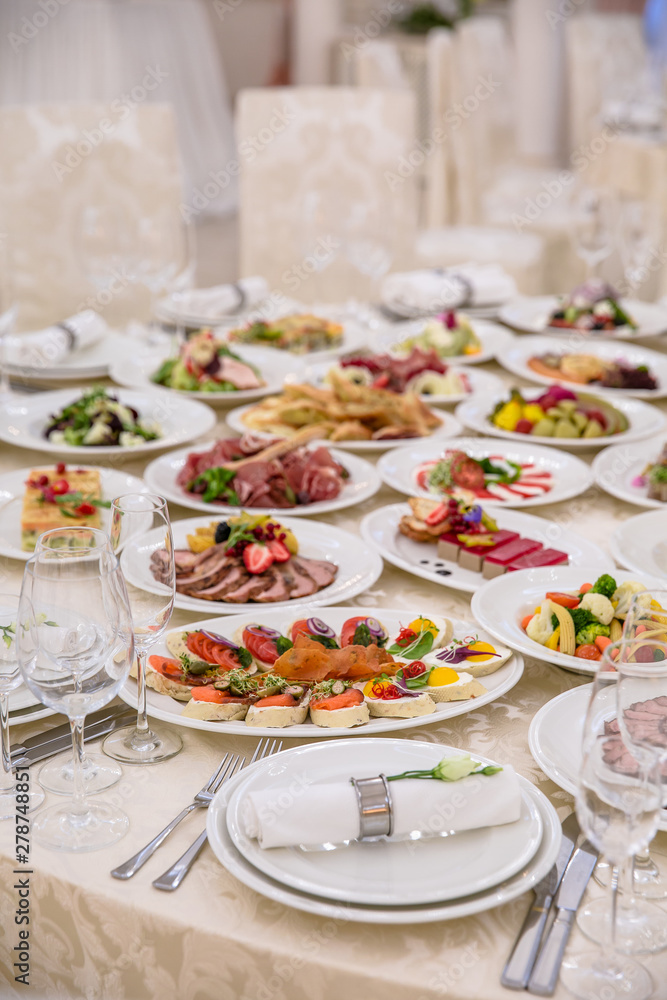 Food Table Celebration Delicious Party Meal Concept. A lot of food. Served for wedding, anniversary, other holiday. Banquet dishes in the restaurant