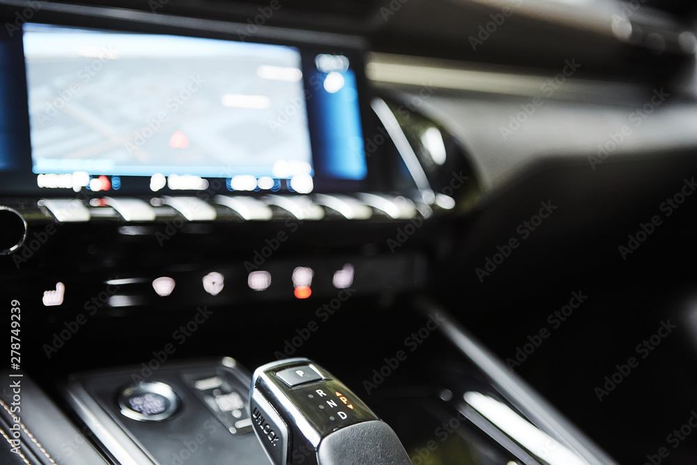 Obraz premium Automotive detail in a luxury car. Modern Luxury car inside. Interior of prestige modern car. Automatic gear stick shift