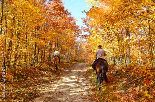 horseback riding on a fall country path 