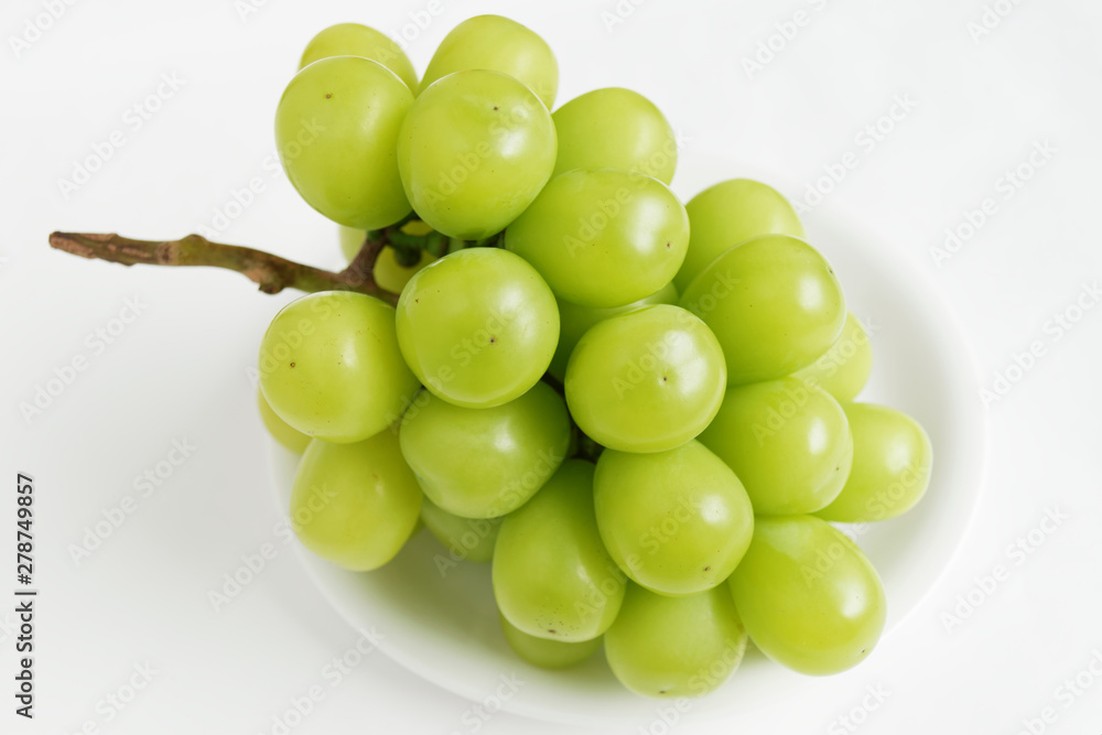 bunch of green grapes on white plate bunch of green grapes on white plate