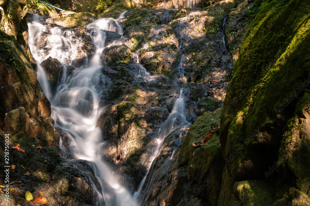 Fototapeta premium Ton Sai Waterfall in the tropical forest area In Asia, suitable for walks, nature walks and hiking, adventure photography Of the national park Phuket Thailand.