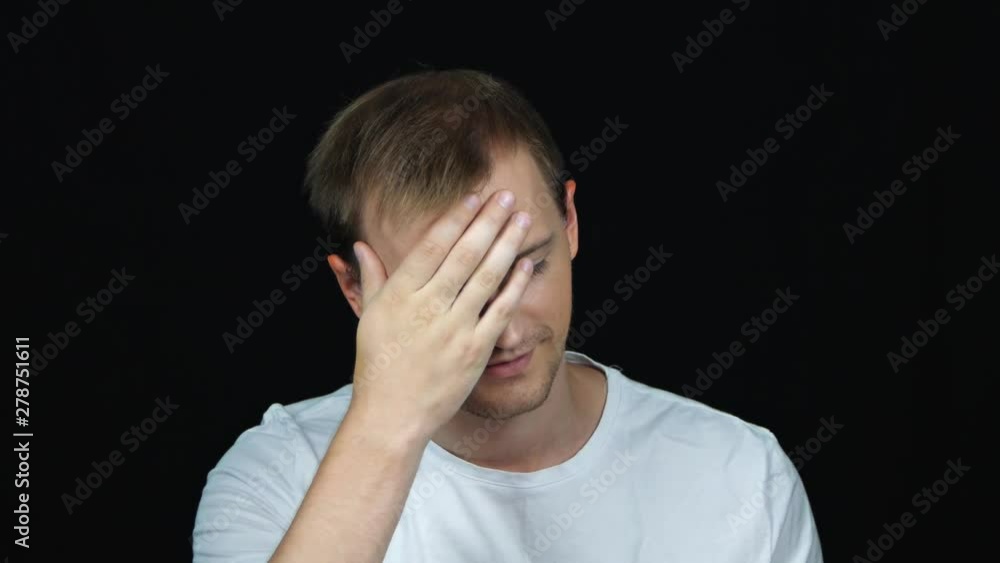 Portrait of annoyed caucasian man covering face like facepalm expressing frustration or shame, over black background. Concept of emotions. Close up. Portrait of annoyed caucasian man covering face like facepalm expressing frustration or shame, over black background. Concept of emotions. Close up.