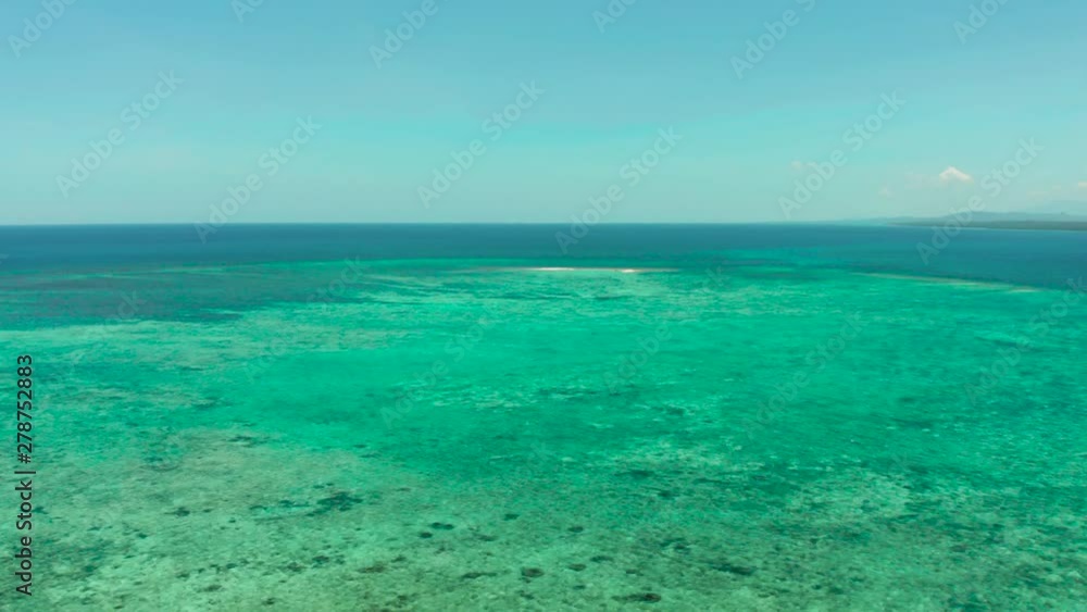 Blue background with transparent sea water copy space for text. Sea water surface in lagoon and coral reef. Top view transparent turquoise ocean water surface. background texture Blue background with transparent sea water copy space for text. Sea water surface in lagoon and coral reef. Top view transparent turquoise ocean water surface. background texture