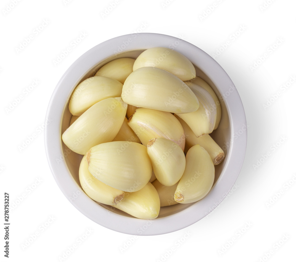 garlic in a bowl isolated on white background. top view