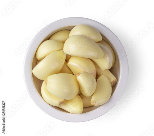 garlic in a bowl isolated on white background. top view