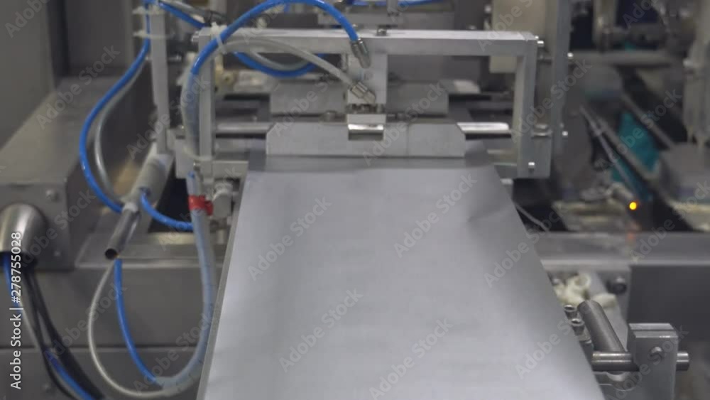 Ice Cream Production Line. Filling waffle cups with ice cream. ice cream factory vanilla chocolate fridge, packaging, waffle cups Ice Cream Production Line. Filling waffle cups with ice cream. ice cream factory vanilla chocolate fridge, packaging, waffle cups